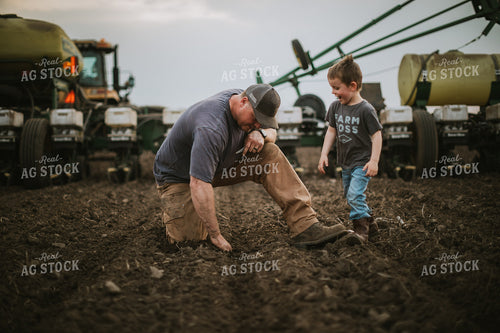 Farmer and Farm Kid Checking Seed Depth 5651