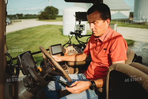 Farmer with Tractor Cab Monitors and Smart Phone 4465