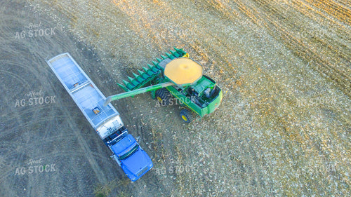 Combine Filling up Semi Trailer with Corn 85011
