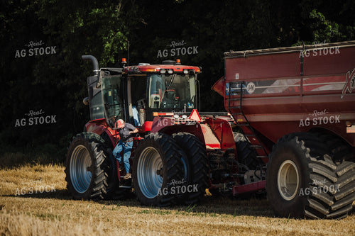 Female Farmer Climbing out of Tractor 115211