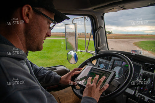 Farmer Checking Tablet in Semi Cab 25551