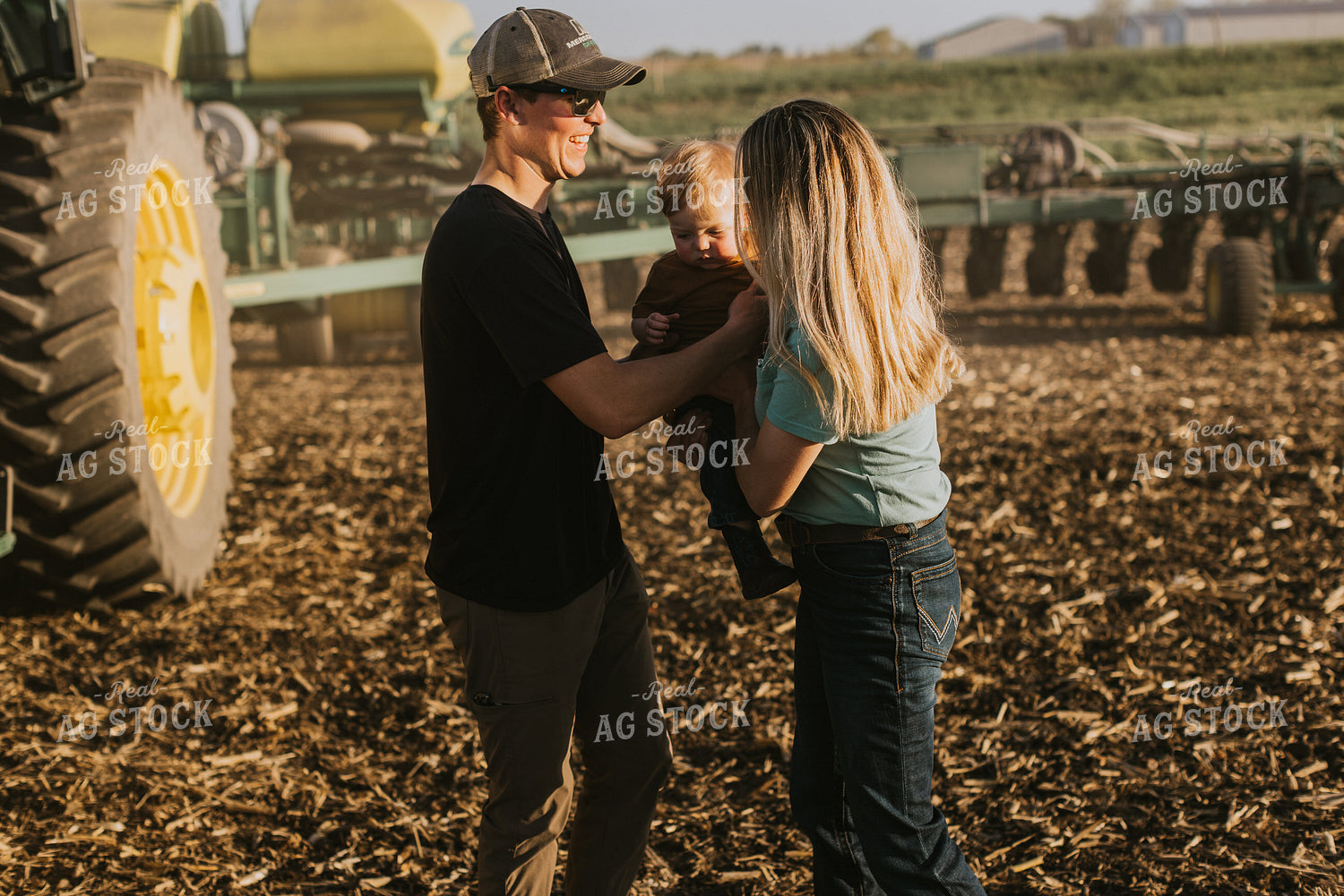 Young Farmer Greeting Family in Field 7664
