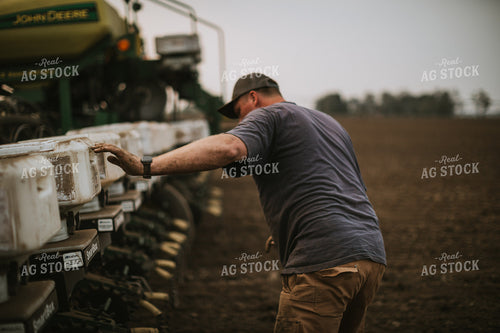 Farmer Adjusting Planter 5689