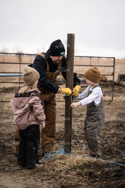 Farmer and Farm Kids Putting up Fence 219002