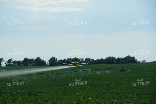 Crop Duster Flying Over Irrigation Pivot and Soybean Field 65003