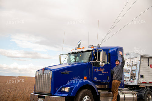 Farmer Climbing into Semi Cab and Waving 25544