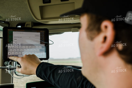 Farmer using Tablet in Tractor Cab 133017