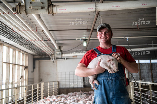 Farmer Holding Piglet 197009