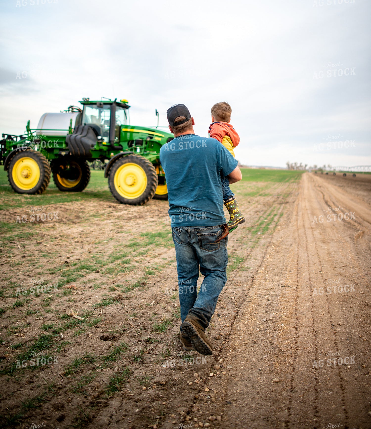 Farmer Holding Farm Kid in Field 56606