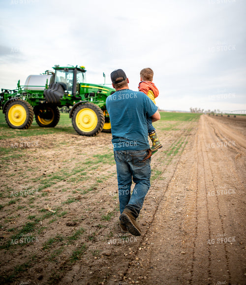 Farmer Holding Farm Kid in Field 56606