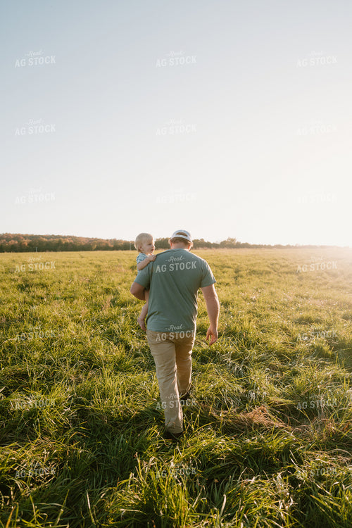 Farmer Checking Pasture with Farm Kid 125351