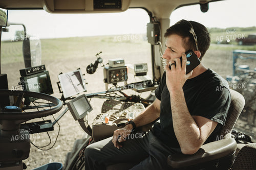 Farmer Talking on Phone in Tractor Cab 4122