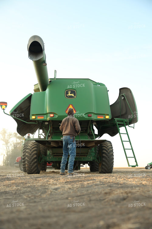 Farmer Blowing out Combine 114099