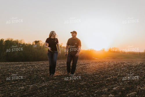 Young Couple Walk in Field at Sunset 7726