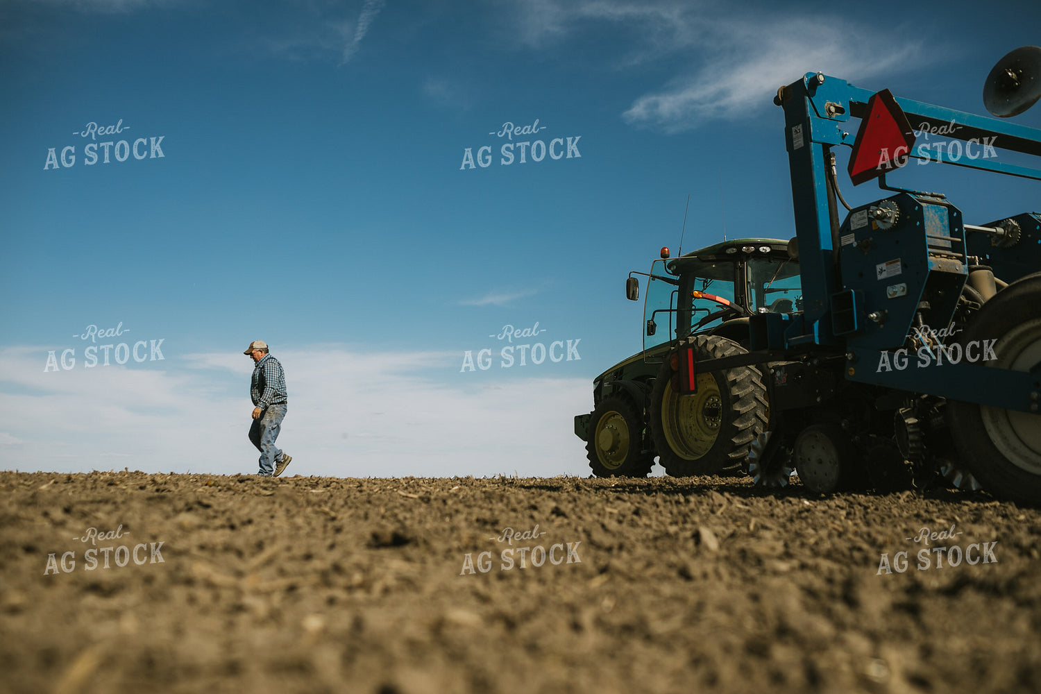 Farmer Climbing out of Tractor with Planter 4103