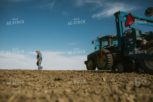Farmer Climbing out of Tractor with Planter 4103