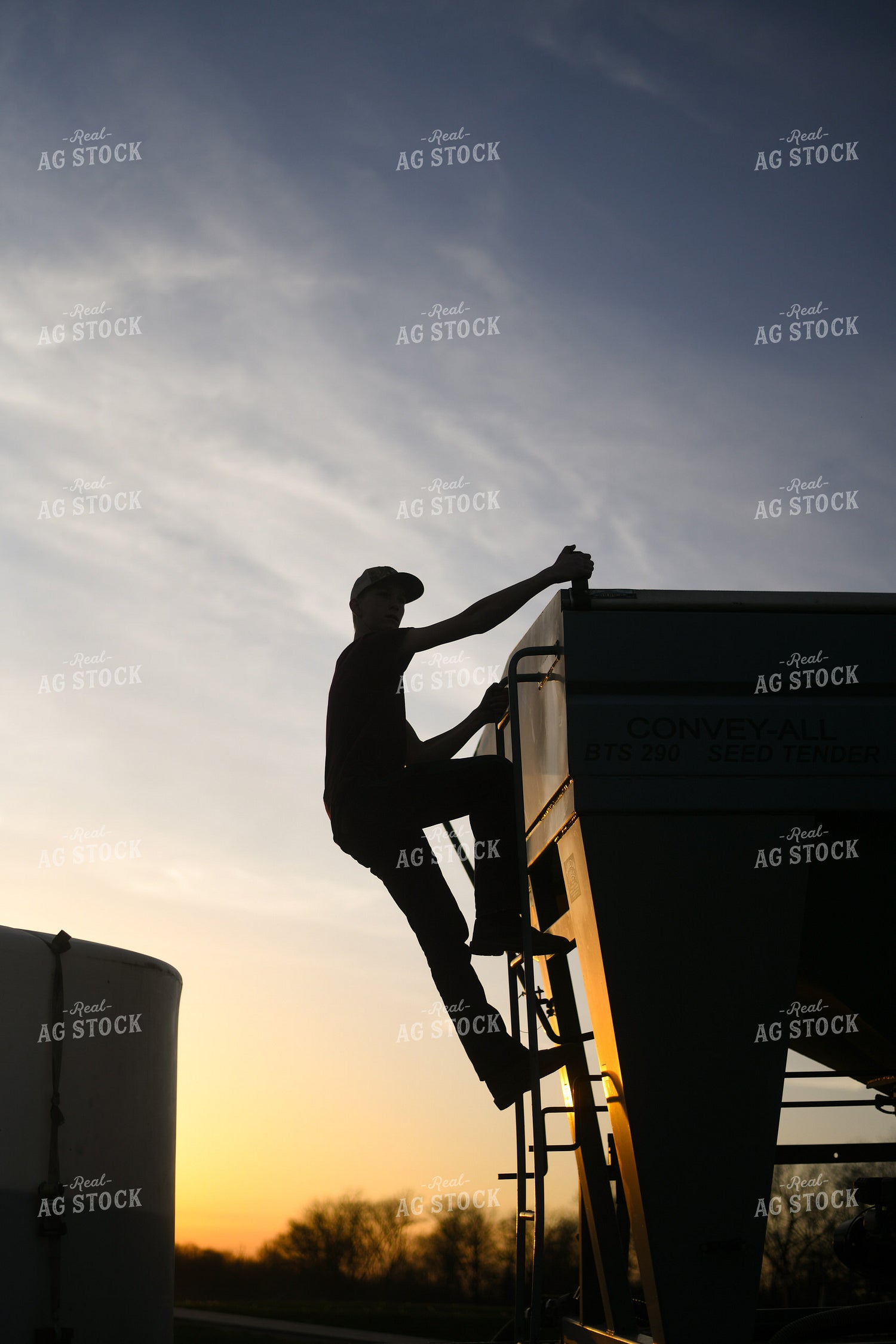 Farmer Climbing up Seed Tender 191010