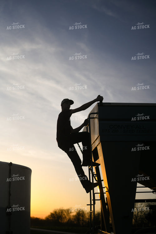 Farmer Climbing up Seed Tender 191010