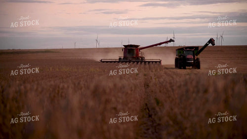 Combine Unloading Soybeans on the go into an Auger Wagon - 519