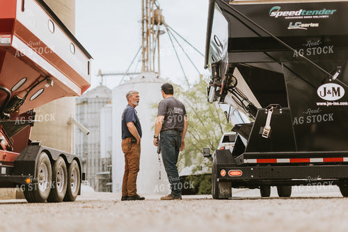 Farmers Talk in Front of Grain Bins 7597