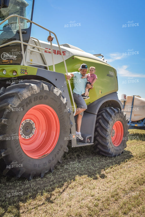 Farmer and Farm Kid Getting out of Forage Harvester 56490