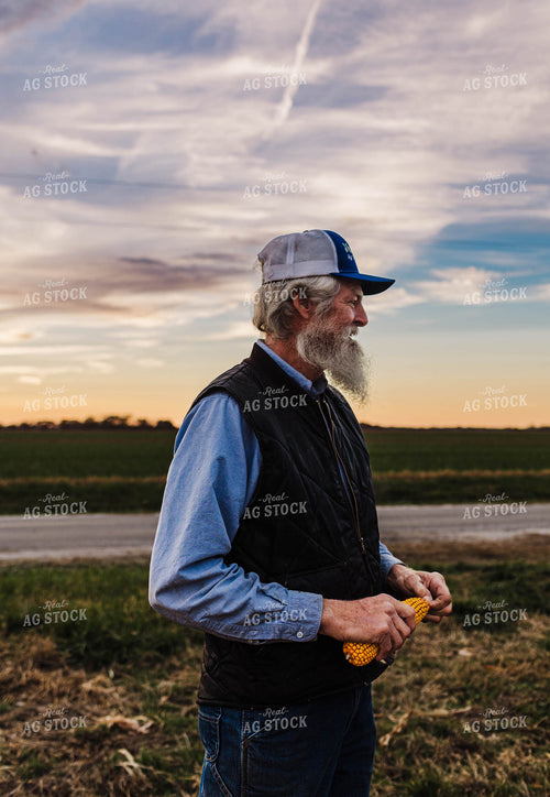 Farmer Holding Ear of Corn 115161
