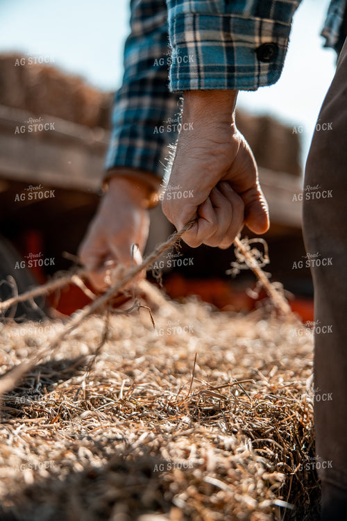 Rancher Moving Hay Bale 250064