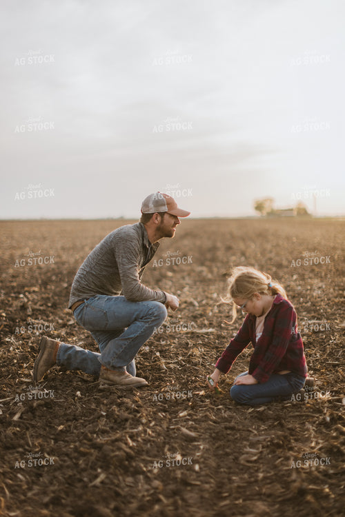 Farmer Checking Seed Depth with Daughter 8227