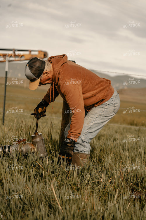 Farmer Working on Irrigation System 58222