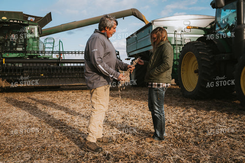 Farmer and Female Farmer Looking at Soybean Plant 3520
