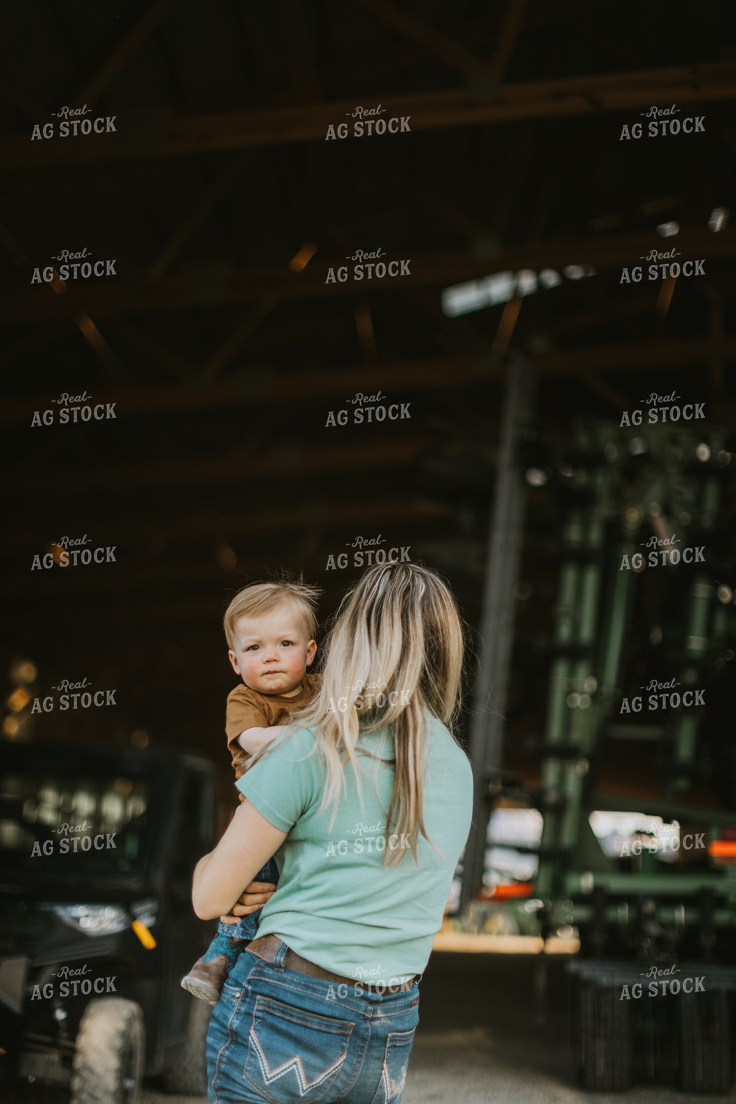 Farm Wife and Child Stand in Shed 7643