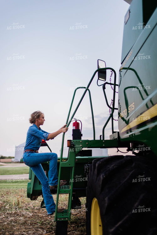 Female Farmer Climbing into Combine 8398