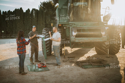 Farm Wife with Phone and Farmers While Working on Combine 5062