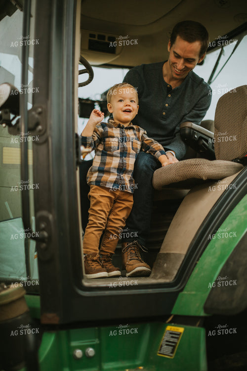 Farmer and Farm Kid in Tractor 6667