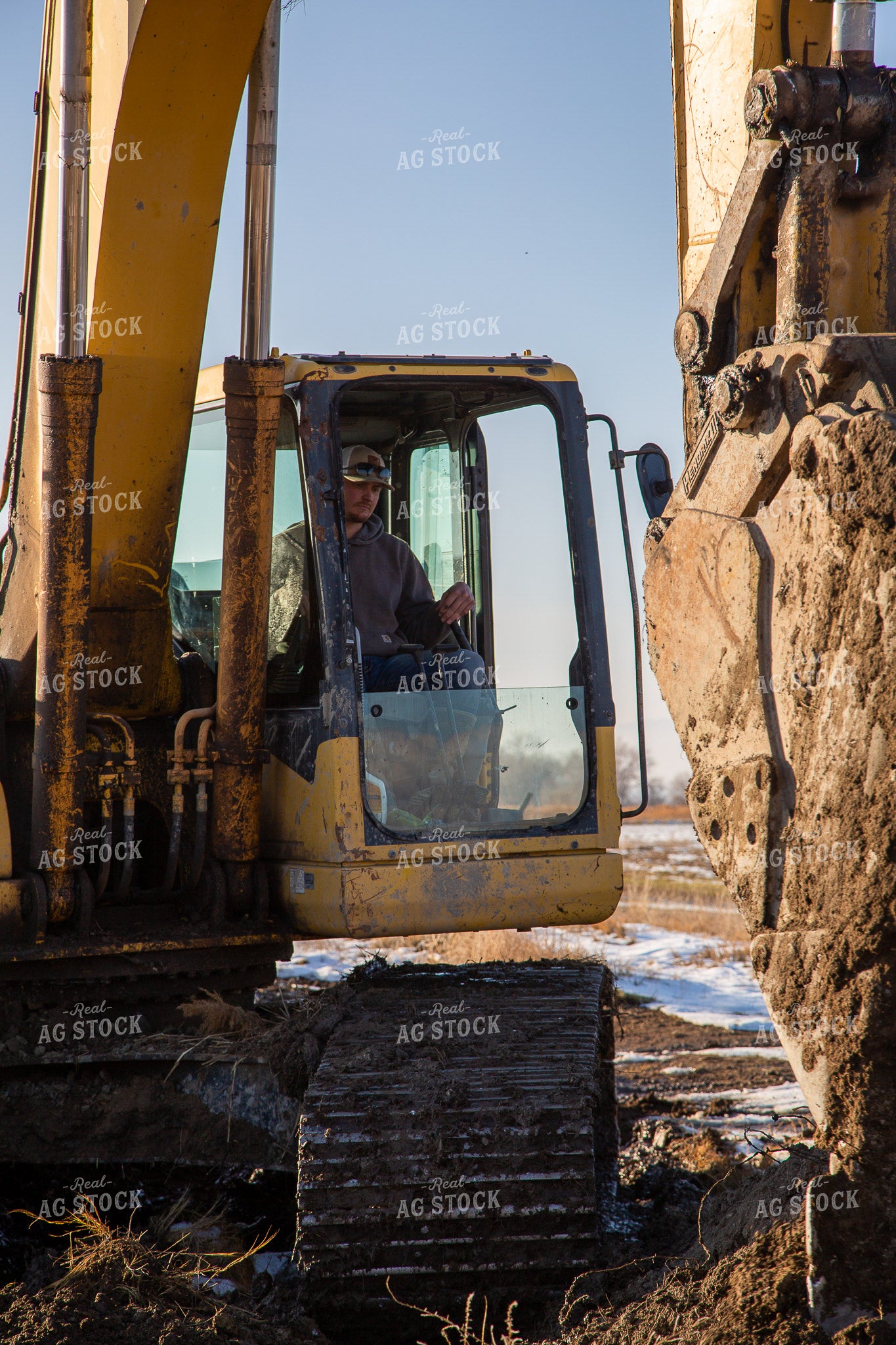 Farmer Operating Excavator 130022