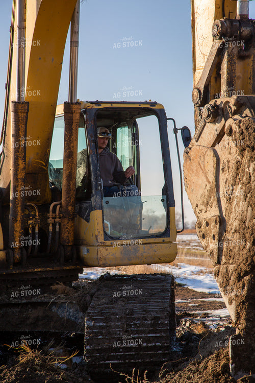 Farmer Operating Excavator 130022