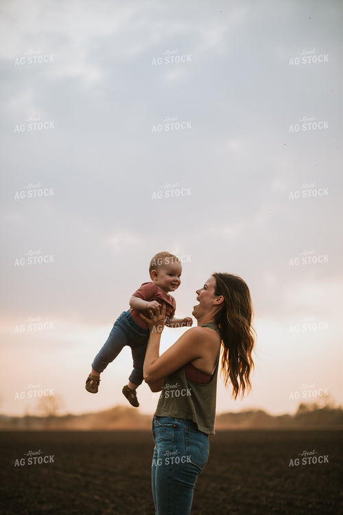 Farm Mom with Farm Kid in Field During Planting 5701