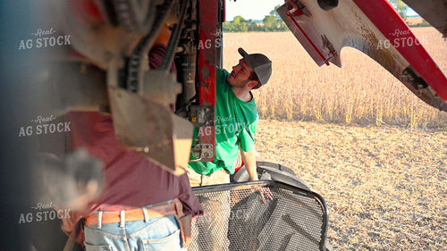 Multigenerational Farm Familiy Repairing Combine in a Bean Field 25513