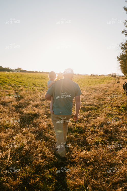 Farmer Checking Cows with Farm Kid 125350