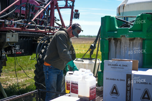 Farmer Mixing Chemicals for Self Propelled Sprayer 191059