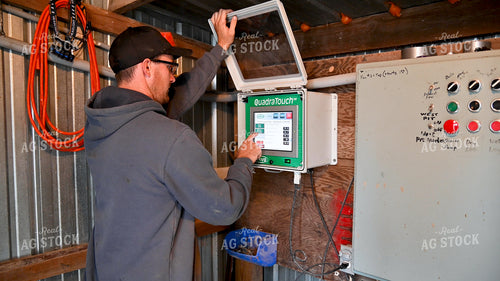Farmer Adjusting Dryer Settings 25615