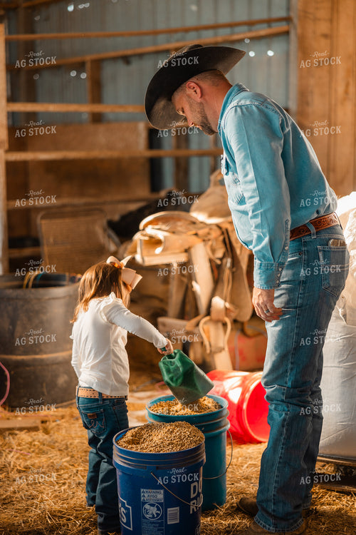 Farmer and Daughter Filling Feed Bucket 256002