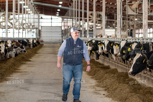 Farmer Walking in Dairy Barn Alley 271010
