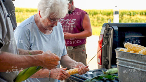 Family Shucking Sweet Corn 25251