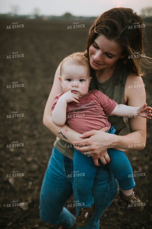 Farm Mom with Farm Kid in Field During Planting 5733