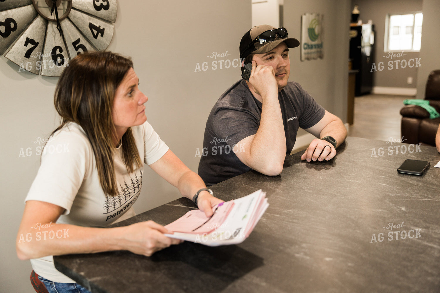 Farmers Review Seed Orders in Farm Office on Phone 7624