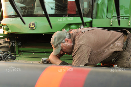 Farmer Fixing Combine Head 187094