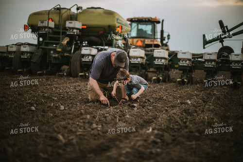 Farmer and Farm Kid Checking Seed Depth 5653