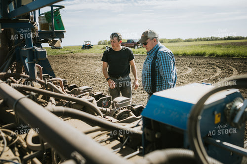 Farmers Adjusting Planter 4278