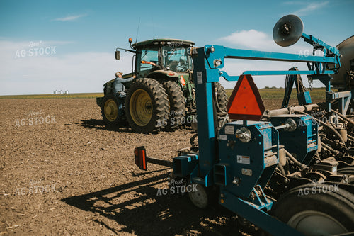 Farmer Climbing into Tractor with Planter 4287
